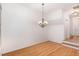 Bright dining room featuring hardwood floors and a modern chandelier, perfect for gatherings at 4618 Pooh Corner Dr, Raleigh, NC 27616
