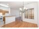 Dining area featuring hardwood floors, chandelier, and view of the kitchen at 4618 Pooh Corner Dr, Raleigh, NC 27616