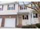 Two-story townhome with attached garage, brick facade, and light yellow vinyl siding at 4618 Pooh Corner Dr, Raleigh, NC 27616