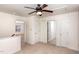 Hallway with neutral carpet and a ceiling fan, offering access to multiple rooms at 4618 Pooh Corner Dr, Raleigh, NC 27616