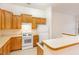 Bright kitchen with tile flooring, white appliances, and light wood cabinets at 4618 Pooh Corner Dr, Raleigh, NC 27616
