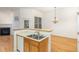 Kitchen featuring tile flooring, breakfast bar, and view of the living room at 4618 Pooh Corner Dr, Raleigh, NC 27616