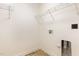 A utility area with hookups and shelving, offering a functional space for laundry appliances at 4618 Pooh Corner Dr, Raleigh, NC 27616