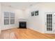 Living room with hardwood flooring, fireplace, and door to the exterior at 4618 Pooh Corner Dr, Raleigh, NC 27616