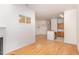 Living room with hardwood flooring, fireplace, and view of the stairs and kitchen at 4618 Pooh Corner Dr, Raleigh, NC 27616