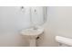 Charming powder room featuring a pedestal sink and classic fixtures, with an adjacent toilet at 4618 Pooh Corner Dr, Raleigh, NC 27616
