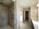 Bathroom featuring a glass-enclosed shower and tile flooring, with a modern sink at 4881 Grosbeak Ct, Mebane, NC 27302