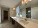 Bathroom featuring double sinks, tile flooring, vanity lighting, and large mirrors at 4881 Grosbeak Ct, Mebane, NC 27302