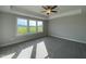 Spacious bedroom featuring large windows and natural light, with plush carpeting at 4881 Grosbeak Ct, Mebane, NC 27302