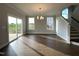 Light-filled dining room featuring hardwood floors, a modern chandelier, and a sliding glass door to the backyard at 4881 Grosbeak Ct, Mebane, NC 27302
