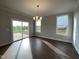 This is a spacious dining room with a sliding glass door and hardwood floors at 4881 Grosbeak Ct, Mebane, NC 27302