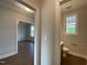 Hallway with view into living room and half bathroom at 4881 Grosbeak Ct, Mebane, NC 27302