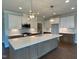 Bright kitchen features a large island, modern stainless appliances, and stylish pendant lighting at 4881 Grosbeak Ct, Mebane, NC 27302
