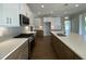 Gourmet kitchen boasts white cabinets, a large island with seating, quartz countertops, and stainless steel appliances at 4881 Grosbeak Ct, Mebane, NC 27302