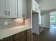 Gourmet kitchen features custom cabinets, quartz countertops, and stainless steel appliances at 4881 Grosbeak Ct, Mebane, NC 27302