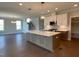 Open concept kitchen and dining area with modern lighting at 4881 Grosbeak Ct, Mebane, NC 27302