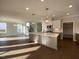 Bright, open kitchen with a large island, hardwood floors, stainless steel appliances and modern pendant lighting at 4881 Grosbeak Ct, Mebane, NC 27302