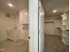 Laundry room featuring sink, cabinets, and view to a separate closet at 4881 Grosbeak Ct, Mebane, NC 27302
