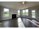 Spacious living room boasts a fireplace, ceiling fan, and hardwood floors, with a door leading to the outdoors at 4881 Grosbeak Ct, Mebane, NC 27302