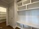 Mudroom with custom built-in shelving, storage, and bench seating leading to a pantry at 4881 Grosbeak Ct, Mebane, NC 27302