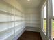 Spacious pantry with custom shelving and a window at 4881 Grosbeak Ct, Mebane, NC 27302