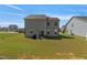 Backyard features a well-maintained lawn, patio area with outdoor seating, and exterior with gray siding at 50 Fontaine Dr, Franklinton, NC 27525
