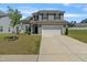 Charming two-story home with gray siding, black shutters, a two-car garage, and a well-manicured lawn at 50 Fontaine Dr, Franklinton, NC 27525