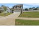 Charming two-story home with gray siding, black shutters, a two-car garage, and a well-manicured lawn at 50 Fontaine Dr, Franklinton, NC 27525