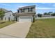 Charming two-story home with gray siding, black shutters, a two-car garage, and a well-manicured lawn at 50 Fontaine Dr, Franklinton, NC 27525