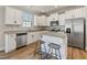 Modern kitchen with stainless steel appliances, granite countertops, and breakfast bar seating at 50 Fontaine Dr, Franklinton, NC 27525