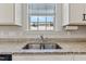 Close-up of kitchen sink with granite countertops and modern fixtures under a bright window at 50 Fontaine Dr, Franklinton, NC 27525