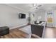 Bright living room with modern ceiling fan, LVP flooring and large gray sectional at 50 Fontaine Dr, Franklinton, NC 27525