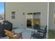 Cozy back patio with sliding door, outdoor seating, and grill, perfect for relaxation and entertainment at 50 Fontaine Dr, Franklinton, NC 27525