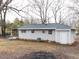 View of the backyard with a shed, small deck, and well-maintained landscaping at 512 Trail Of Merlin, Garner, NC 27529