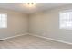 Neutral bedroom with carpet flooring, overhead lighting, and two windows at 512 Trail Of Merlin, Garner, NC 27529