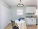 Cozy dining room featuring a chandelier, white floors, and a large closet at 512 Trail Of Merlin, Garner, NC 27529