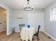 Cozy dining room featuring a chandelier, white floors, and a large closet at 512 Trail Of Merlin, Garner, NC 27529
