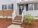 A close-up of the front door with brick stairs and fresh landscaping at 512 Trail Of Merlin, Garner, NC 27529