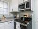 Close-up of a kitchen featuring stainless steel appliances and a view out the window at 512 Trail Of Merlin, Garner, NC 27529