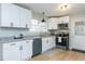 Bright kitchen with stainless steel appliances, granite countertops, and modern white cabinets at 512 Trail Of Merlin, Garner, NC 27529