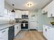 Well-lit kitchen featuring stainless steel appliances, granite countertops, and stylish light fixture at 512 Trail Of Merlin, Garner, NC 27529