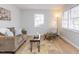 Cozy living room with neutral colors, hardwood floors, and natural light at 512 Trail Of Merlin, Garner, NC 27529