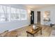 Bright living room with hardwood floors, modern lighting, and large windows at 512 Trail Of Merlin, Garner, NC 27529