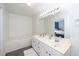Bright bathroom features double sinks, a large mirror, and a luxurious soaking tub at 521 Renshaw Ct, Cary, NC 27518