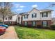 A row of townhouses with brick and siding, green shutters and well-maintained lawns create inviting curb appeal at 521 Renshaw Ct, Cary, NC 27518