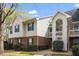 Townhouse exterior with brick and siding, green shutters, and a covered entrance creates curb appeal at 521 Renshaw Ct, Cary, NC 27518