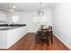 Eat-in kitchen featuring stainless steel appliances, granite countertops, and a modern light fixture at 521 Renshaw Ct, Cary, NC 27518