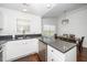 Bright kitchen features white cabinets, stainless steel appliances, and durable countertops at 521 Renshaw Ct, Cary, NC 27518