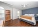 Spacious primary bedroom boasts hardwood floors, great lighting, and a calming color palette at 521 Renshaw Ct, Cary, NC 27518