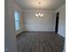 Formal dining room featuring dark wood floors, modern wainscotting, and a contemporary chandelier at 530 Sweet Potato Lane # 41, Nashville, NC 27856